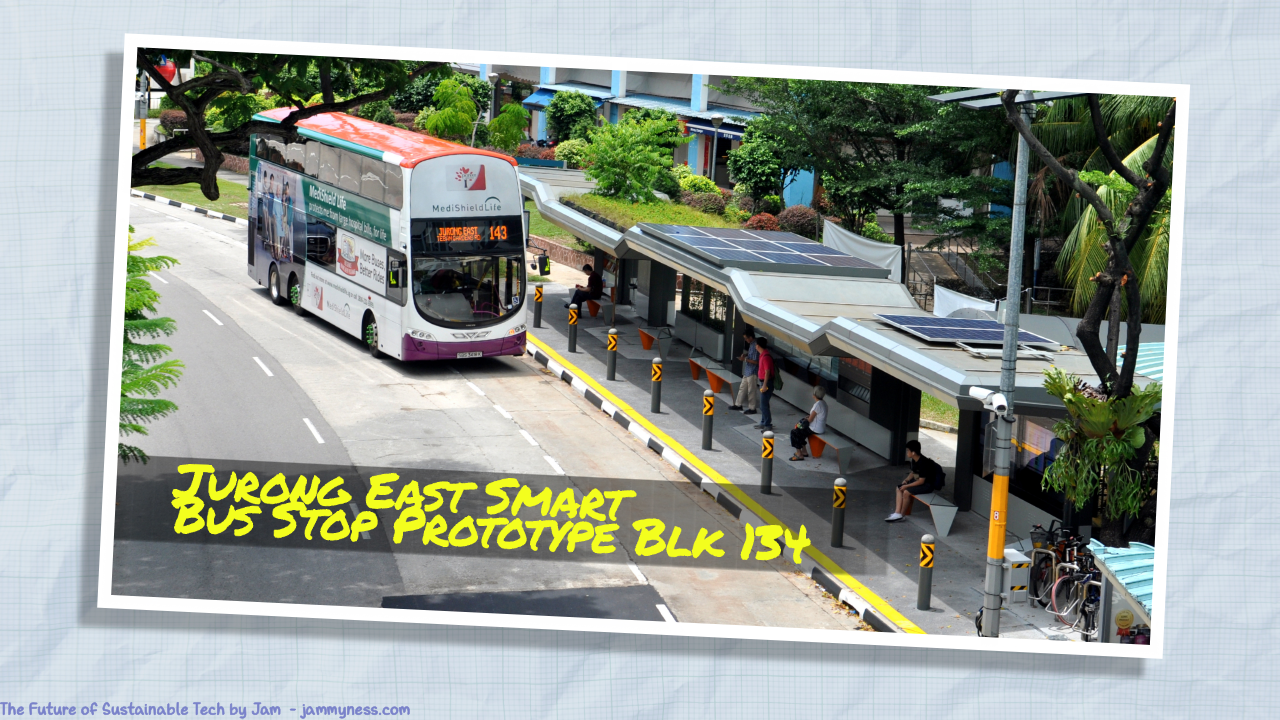 Photo of a bus stop in Singapore with solar panels and green roofs. A double-decker bus is pulling up to it. The caption reads Jurong East Smart Bus Station, link below.